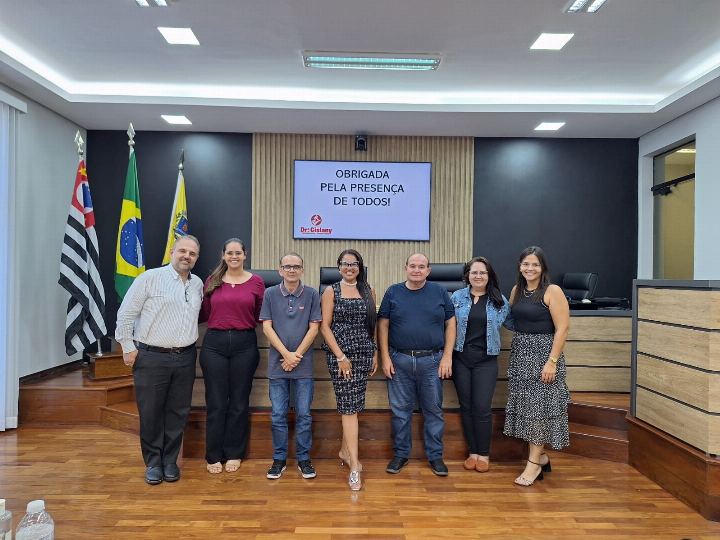 Participantes com os certificados no plenário, ao lado das bandeiras oficiais